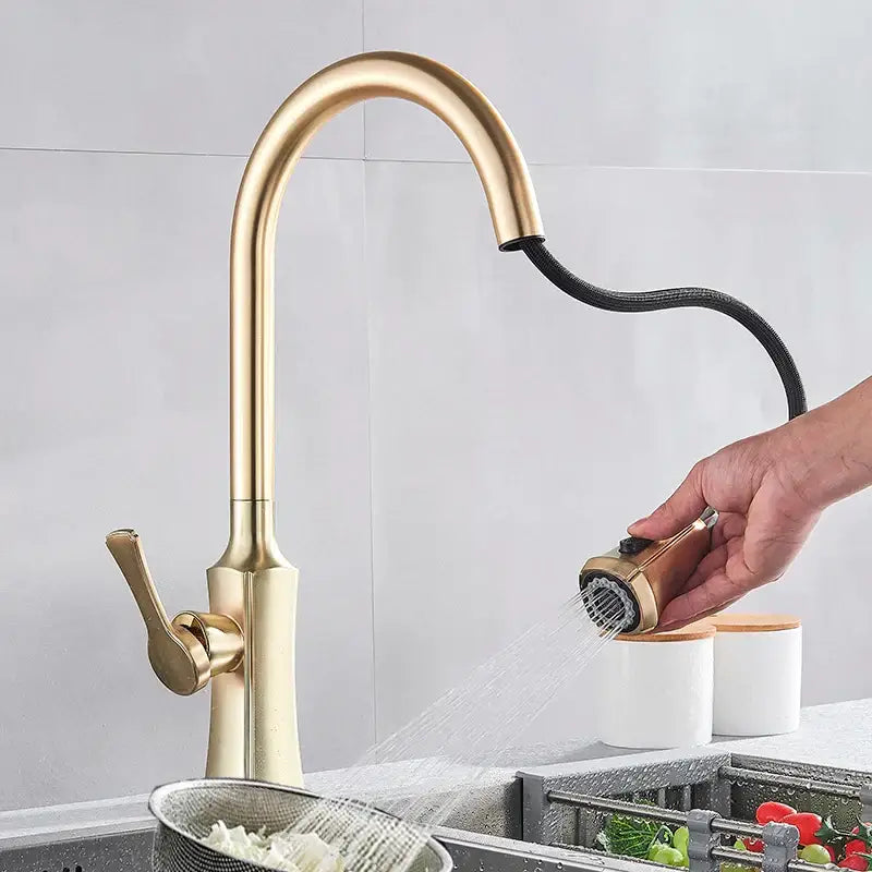 Modern brushed gold kitchen faucet with a sleek curved spout and extendable pull out spray head by decorbites brushed gold