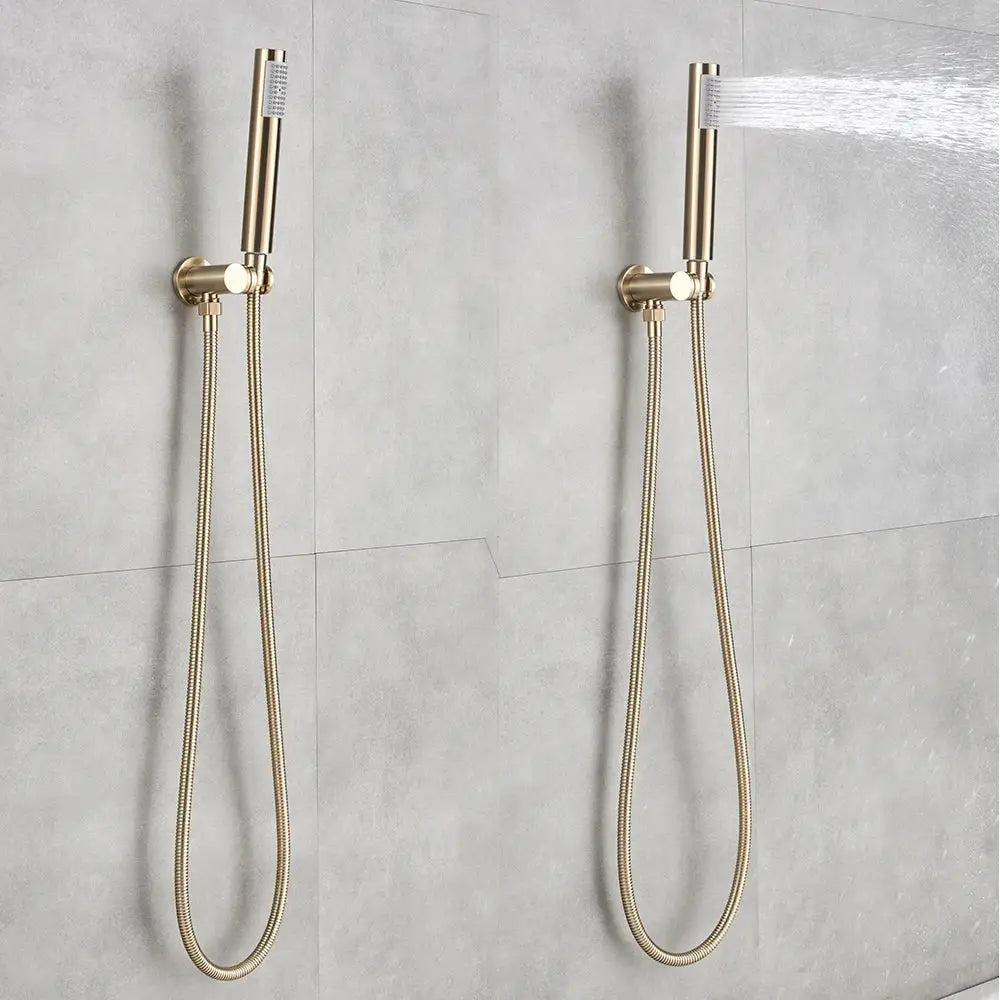 Two sleek brushed gold rainfall shower heads with flexible braided hoses in a modern shower set mounted on tiled wall