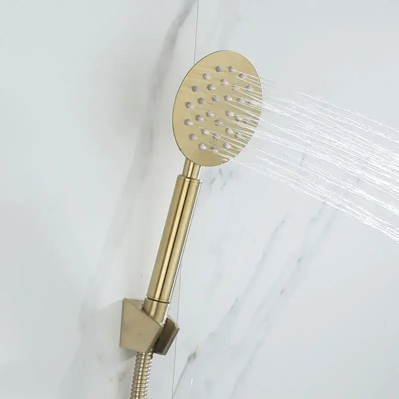 Modern brushed gold shower faucet set featuring a gold-toned round showerhead with multiple water jets