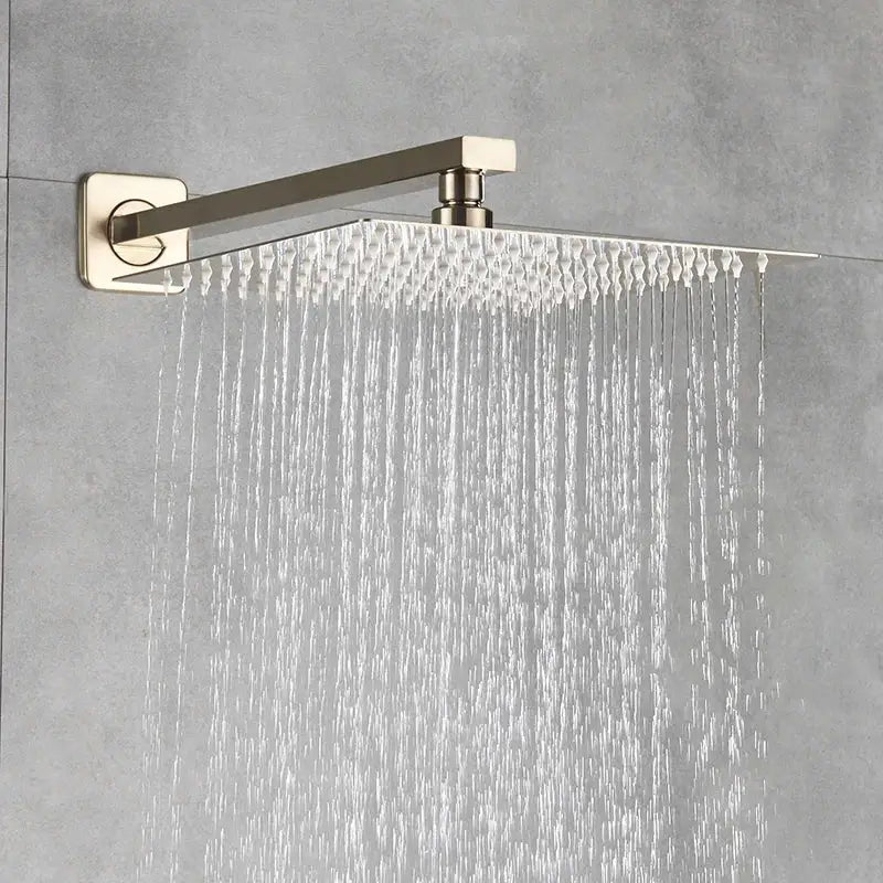 Modern brushed gold shower mixer with rainfall head featuring a brushed nickel square showerhead and minimalist design