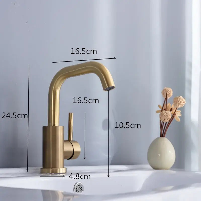 Modern brushed gold basin faucet with single handle, curved spout, and brass-finished cylindrical base for bathroom use