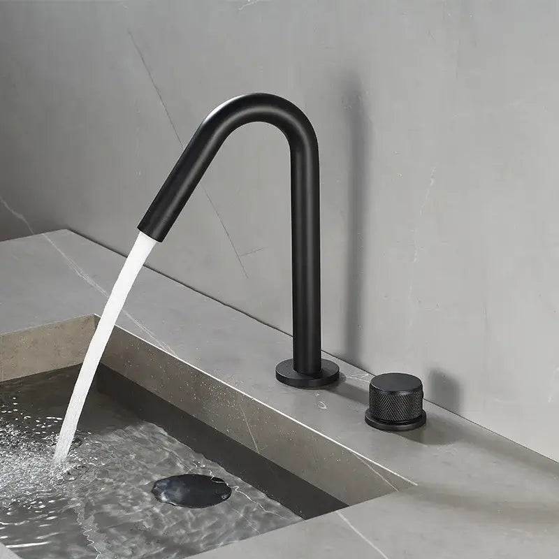 Modern brushed gold single handle bathroom basin faucet with black matte curved spout and premium ceramic valve knob