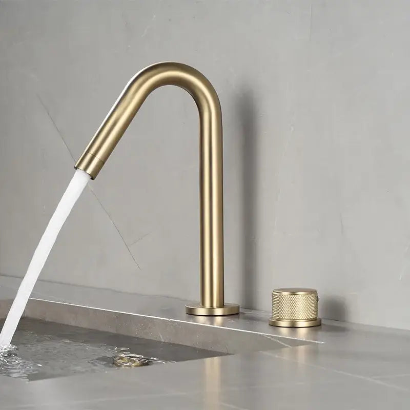 Modern brushed gold single handle bathroom basin faucet with brass finish, sleek curved spout, and premium ceramic valve