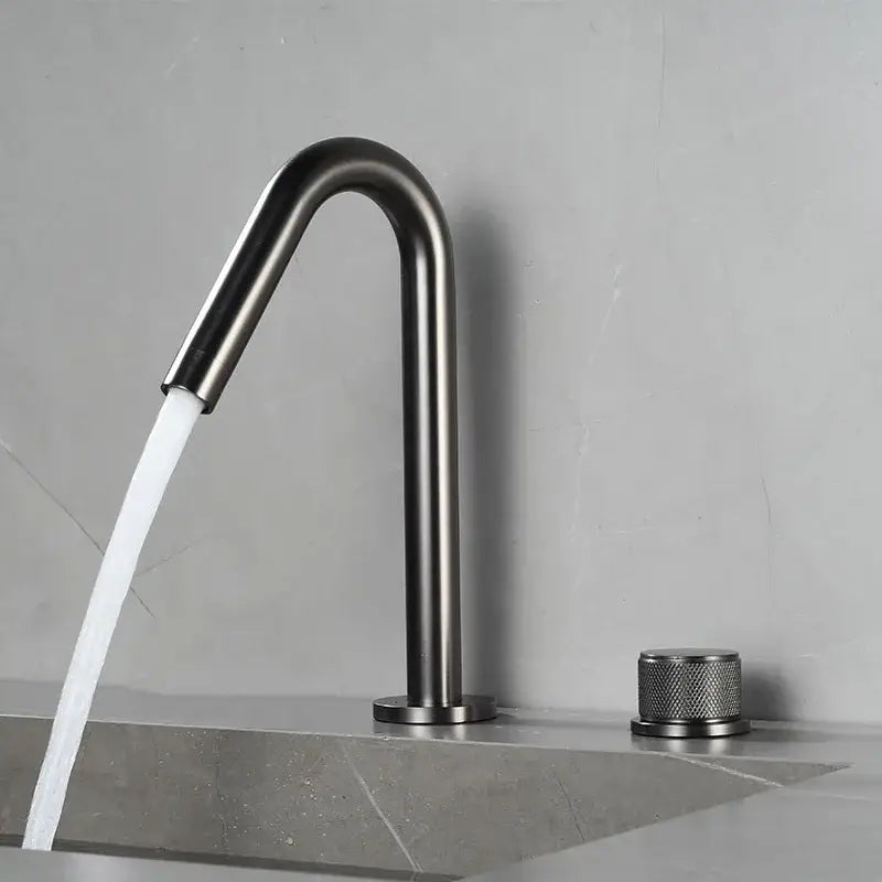 Modern brushed gold single handle bathroom basin faucet with matte black curved spout and premium ceramic valve