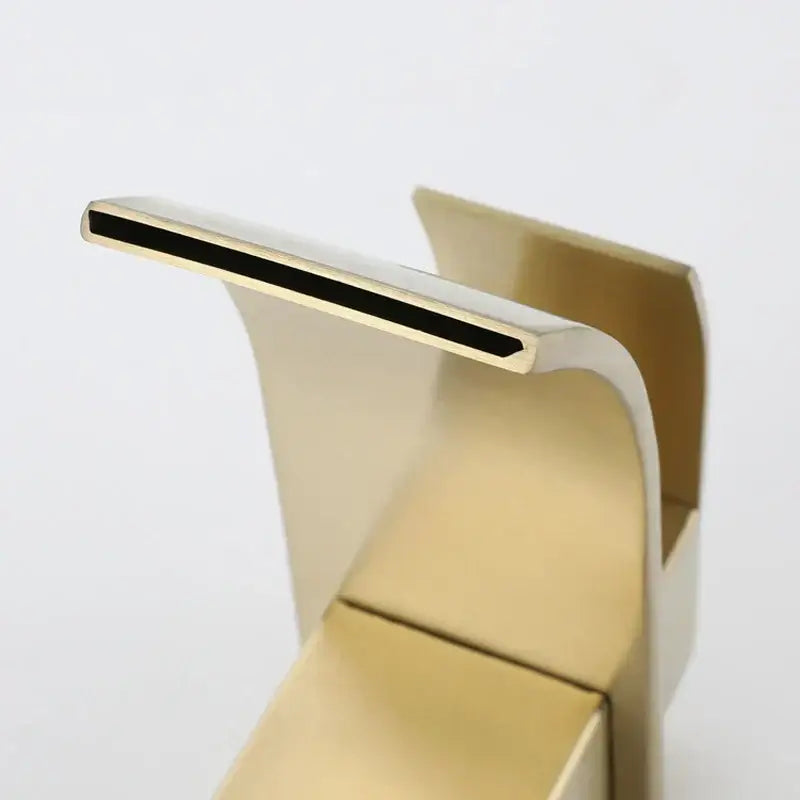 Modern brushed gold stainless steel basin faucet with a sleek curved design and rectangular spout for bathroom use