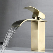 Modern brushed gold stainless steel basin faucet with sleek waterfall design and brushed metal finish for bathroom
