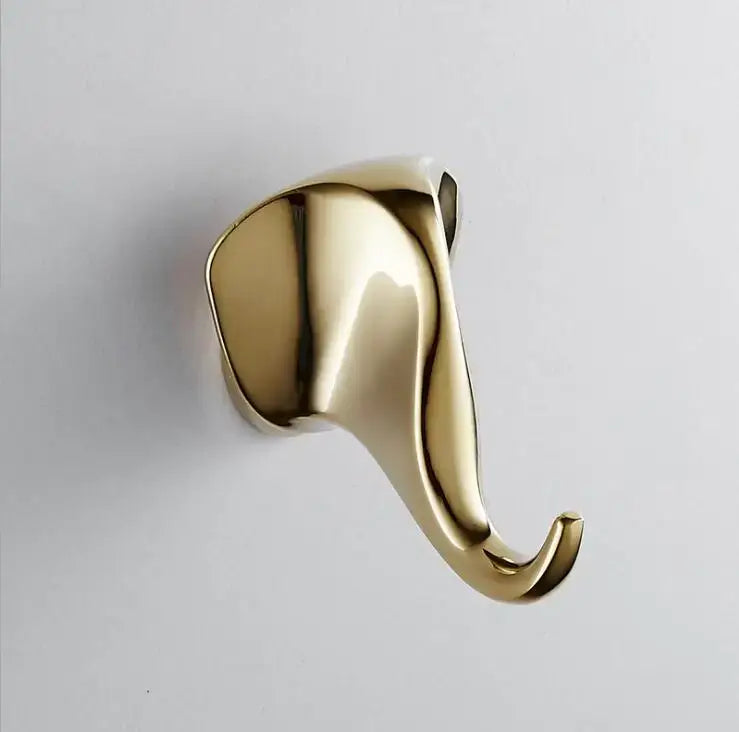 Modern brushed gold stainless steel robe hook shaped like a sleek curved elephant with polished metallic finish