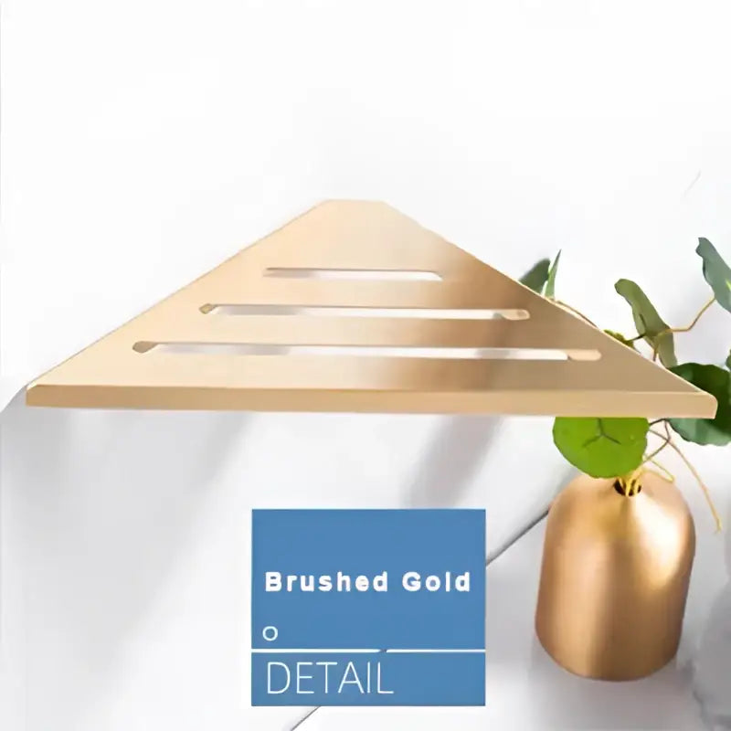 Modern brushed gold stainless steel triangular wall-mounted shelf with horizontal slats for shower storage