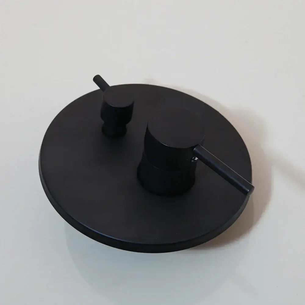 Modern brushed gold shower tub faucet with black matte circular wall-mounted handles for hot and cold water control