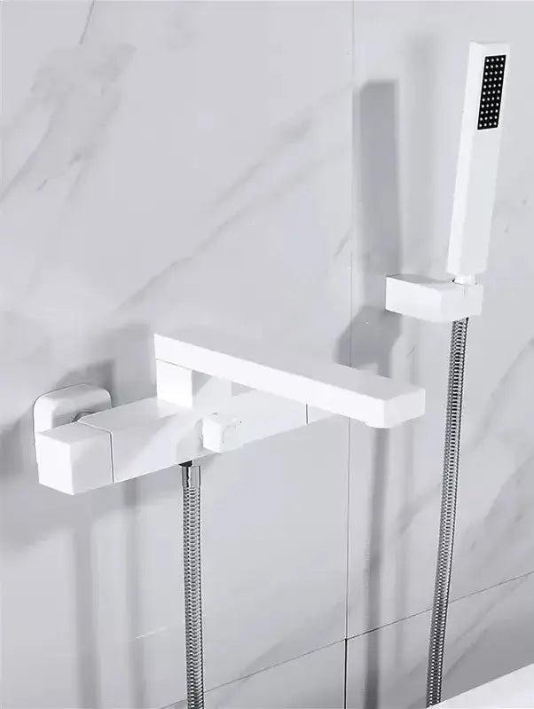 Modern brushed gold wall mounted waterfall bathtub set with a sleek white bathroom faucet and matching handheld showerhead