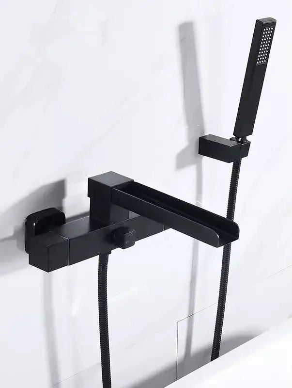 Black matte modern bathtub faucet with integrated handheld showerhead complementing decorbites brushed gold wall set