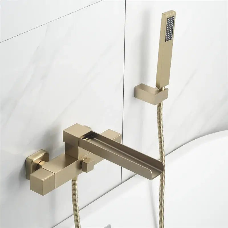 Modern brushed gold wall mounted waterfall bathtub set with sleek angular decorbites brushed gold faucet and handheld