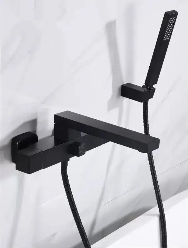 Black matte modern bathroom faucet with integrated handheld showerhead complementing decorbites brushed gold wall decor