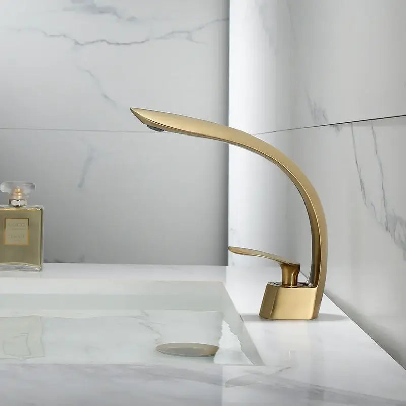 Modern brushed gold waterfall basin faucet with sleek curved design in decorbites brushed gold finish for bathroom use