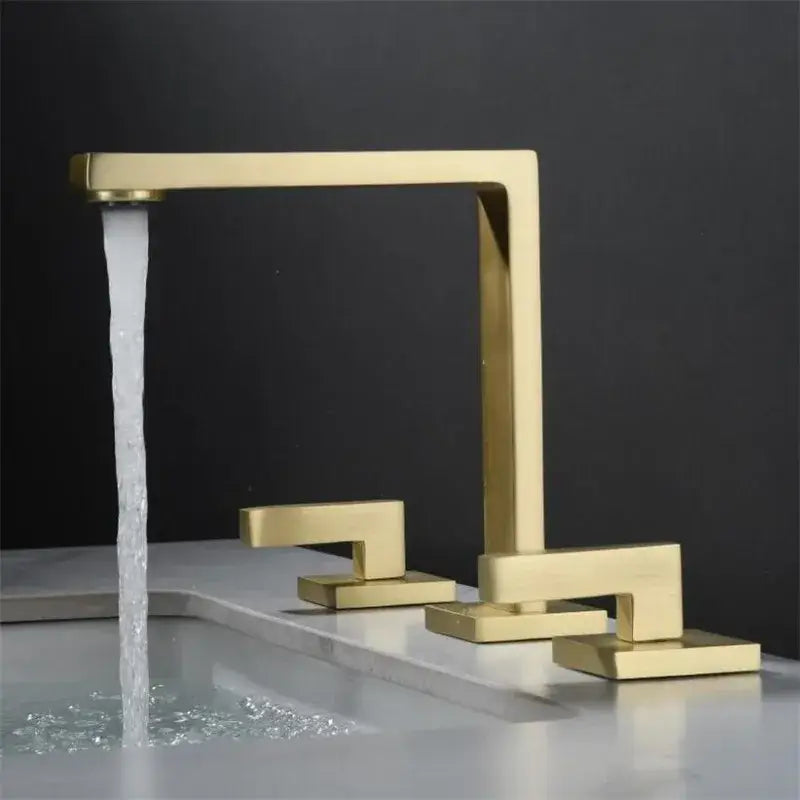 Modern brushed gold basin faucet with sleek angular design and three handles by decorbites for bathroom sinks