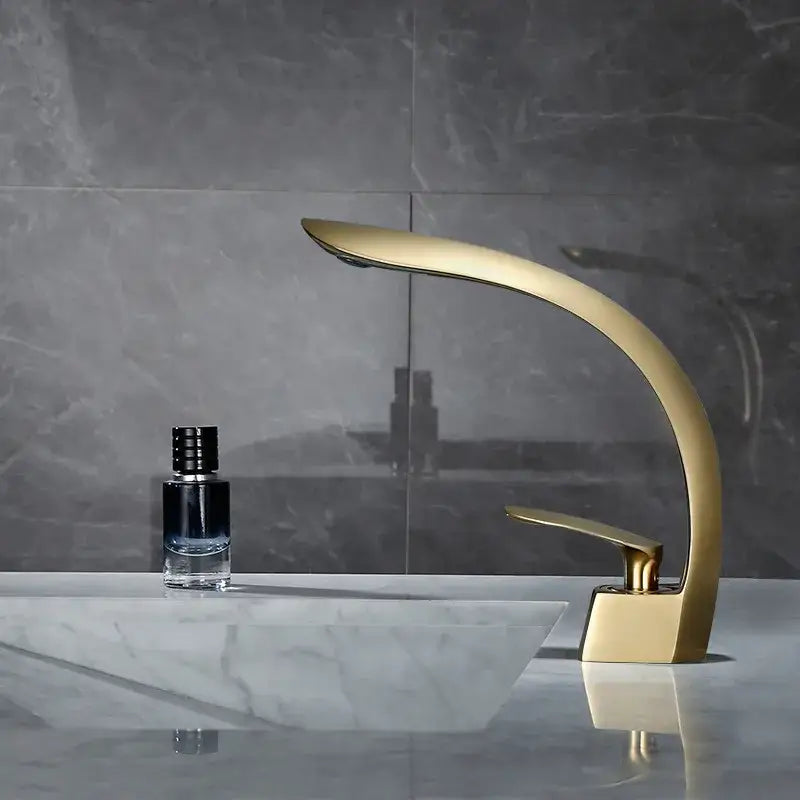 Modern brushed gold waterfall basin mixer tap with sleek curved design for bathroom basin mixer use