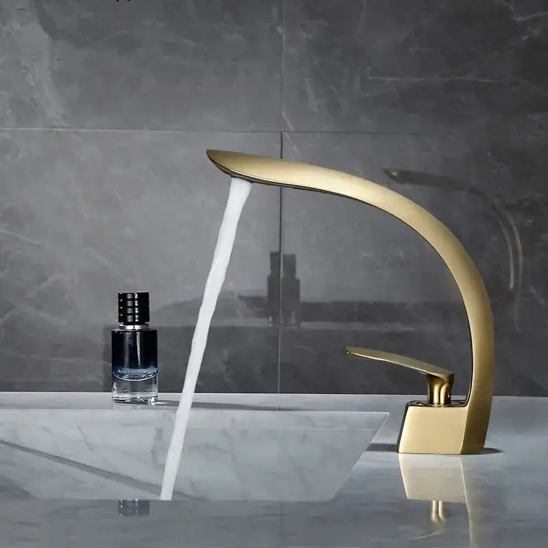 Modern brushed gold waterfall basin mixer tap with sleek curved design for stylish bathroom sink use