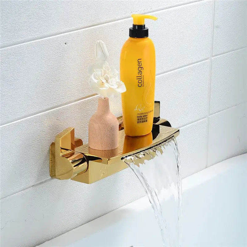 Modern brushed gold waterfall shower faucet set features a gold-toned bathroom shelf holding lotion and wooden vase