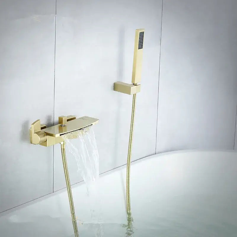 Modern brushed gold waterfall shower faucet set with gold-toned faucet and matching handheld showerhead for bathroom use