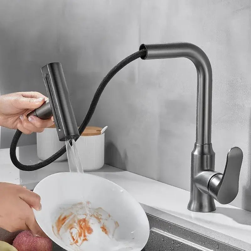 Black matte pull-down kitchen faucet with flexible hose and sleek design for modern gray waterfall kitchen use