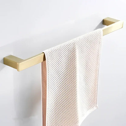 Modern brushed matt gold decorbites bath set towel rack in gold tone holding a light pink mesh towel for bathroom use