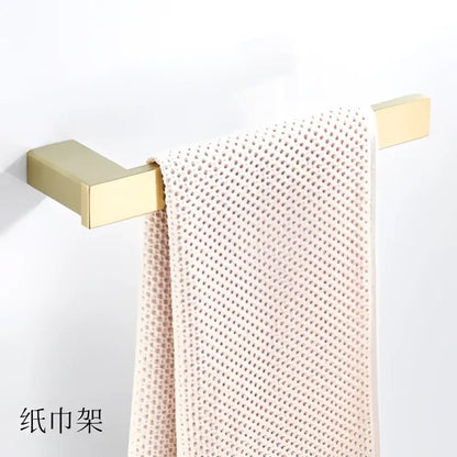 Modern brushed matt gold decorbites bath set featuring a gold rectangular towel rack with a textured off-white towel