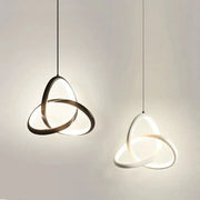 Modern brushed metal and white led bedside pendant light with interlocking circular rings emitting soft glow decorbites led bedside