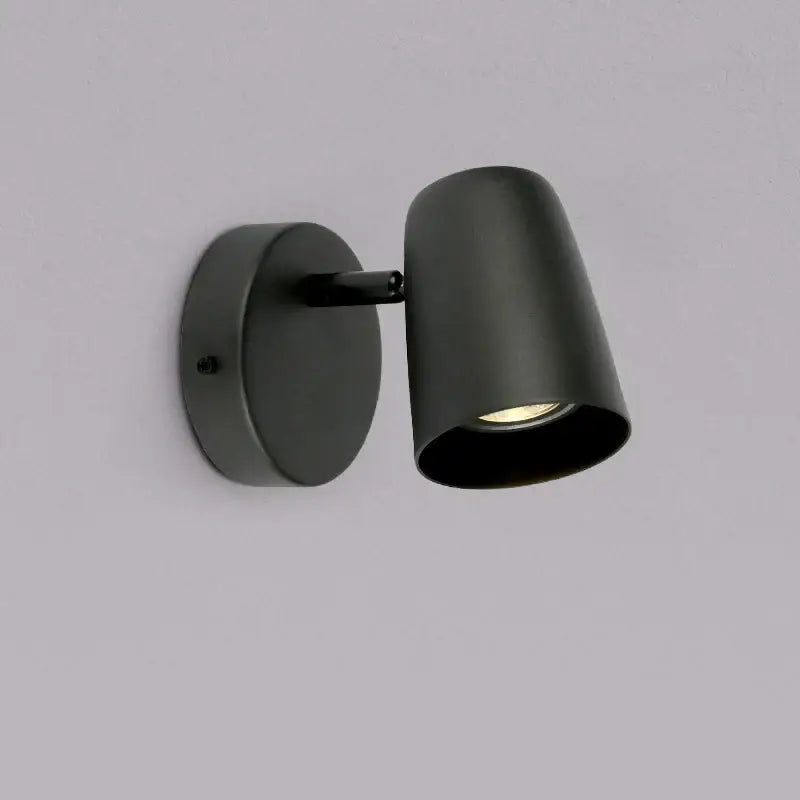 Black matte finished modern adjustable led wall lamp with cylindrical head and circular base for bedroom lighting