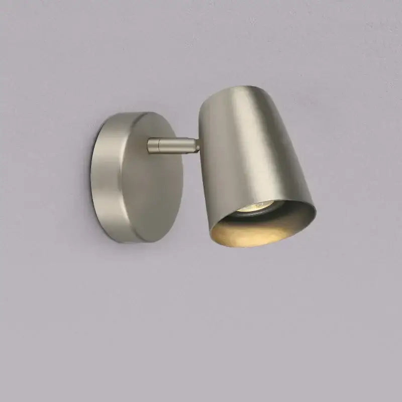 Modern brushed nickel led wall lamp with adjustable arm and sleek conical shade for bedroom lighting