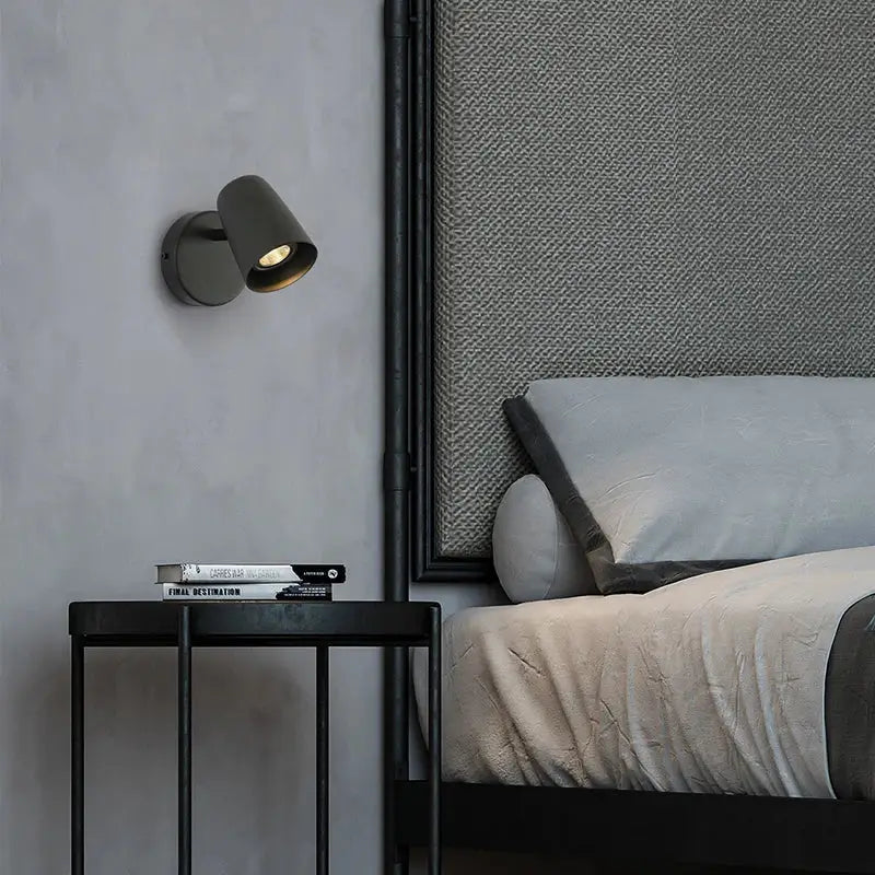 Dark gray metallic led wall lamp with a sleek modern design and adjustable spotlight for bedroom use