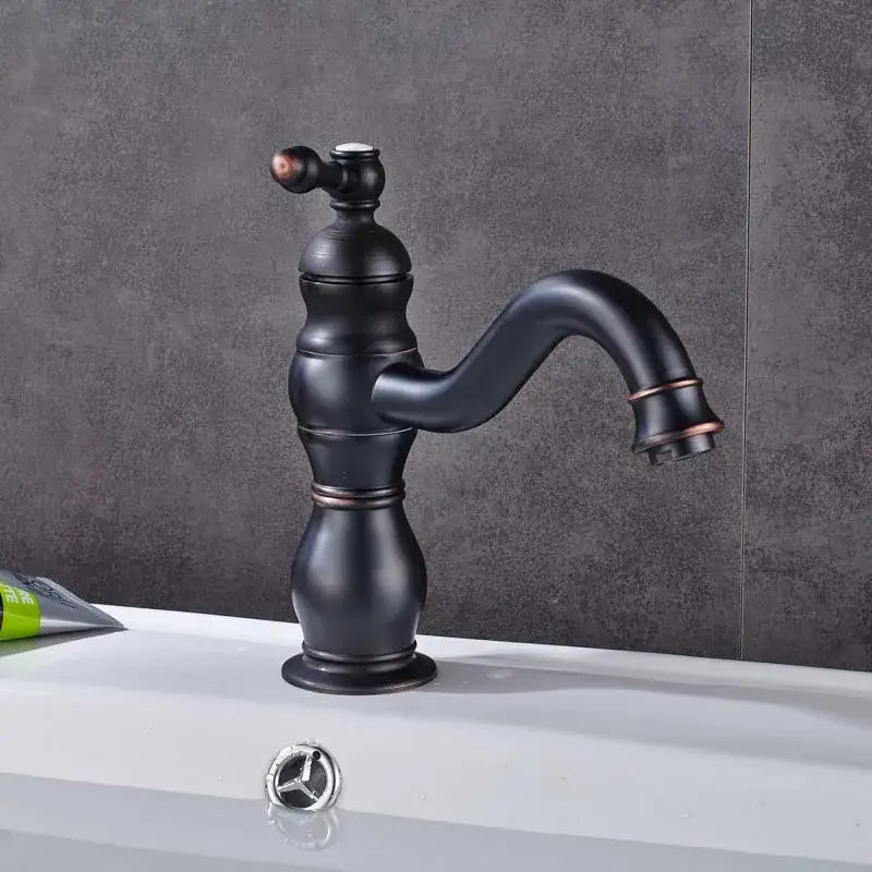 Antique black finish basin faucet with copper accents and classic curved spout paired with modern brushed nickel long spout design