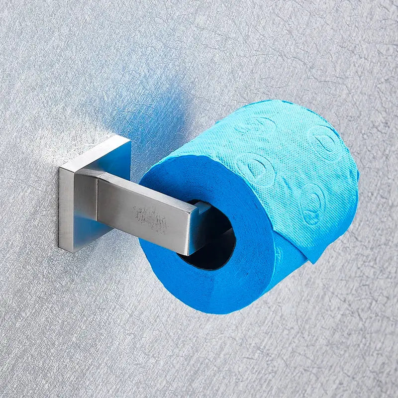 Bright blue toilet paper roll with embossed patterns on brushed nickel wall-mounted holder in bathroom hardware set