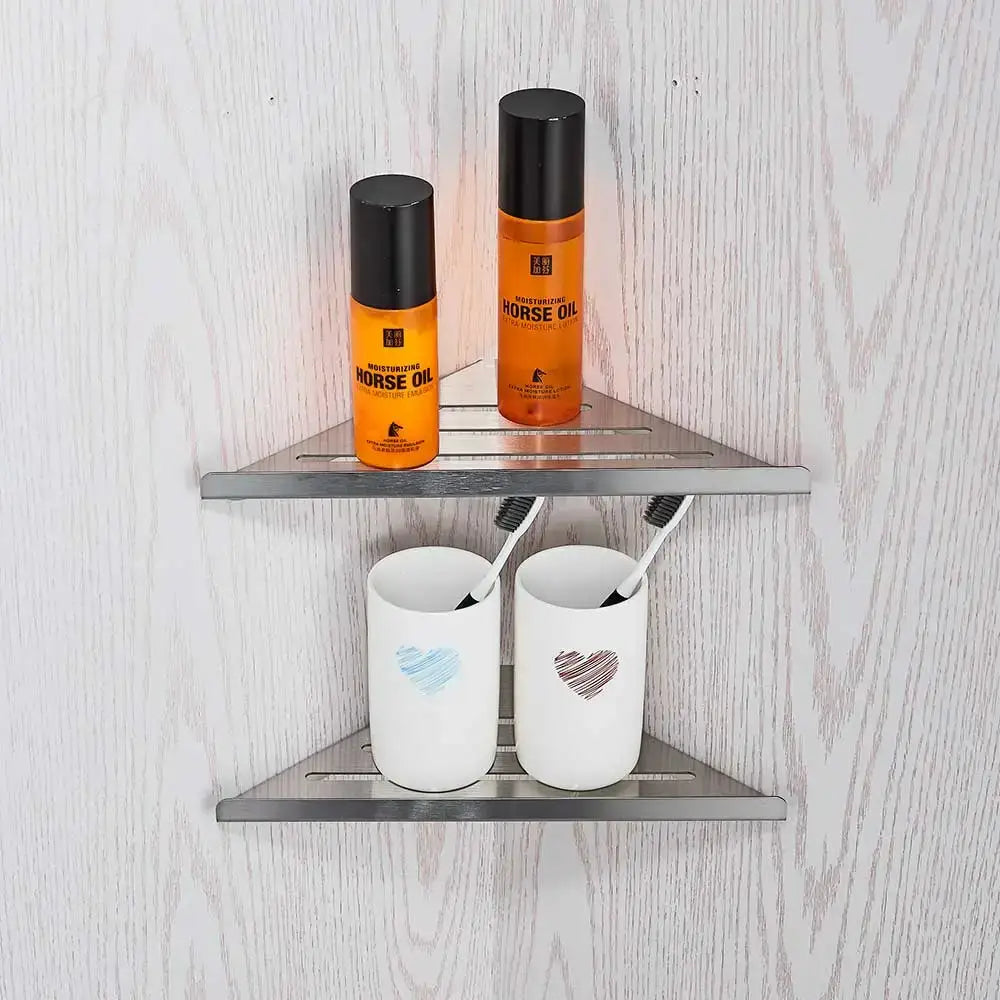 Stainless steel triangular wall shelf with two tiers in a modern brushed nickel bathroom hardware set with glass accents
