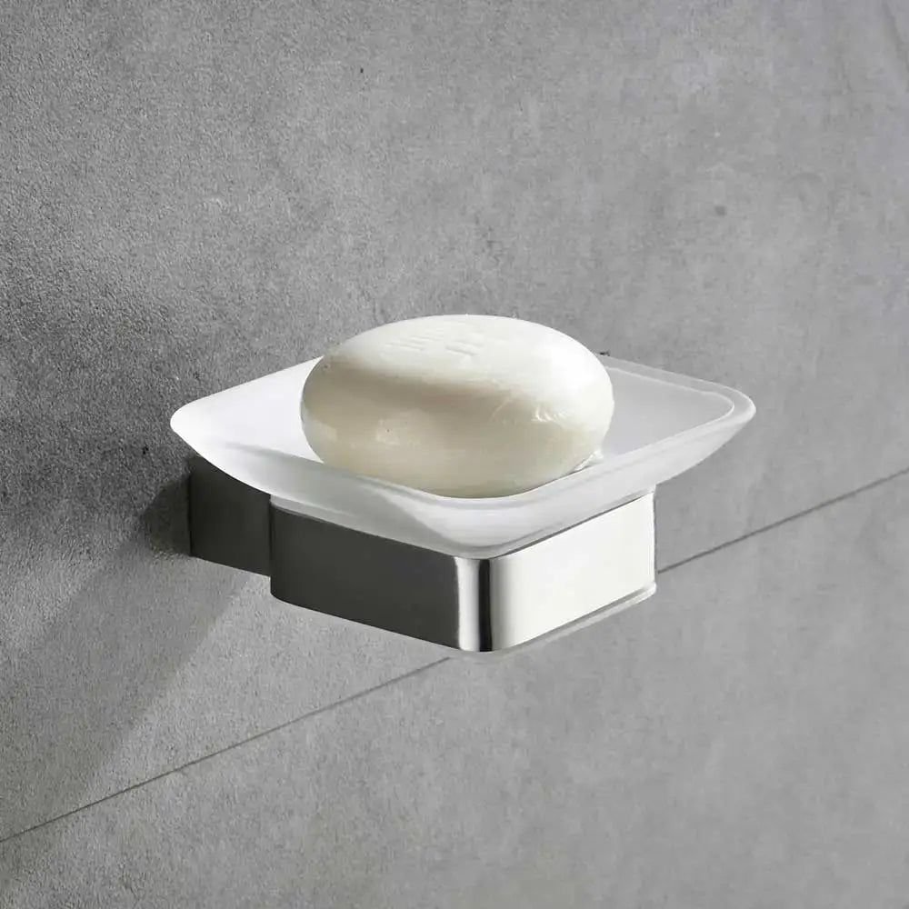 Modern frosted glass soap dish with stainless steel base holding white soap from bathroom hardware set