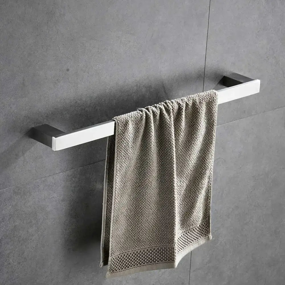 Modern brushed nickel bathroom hardware set features a sleek chrome towel rack with matte finish holding a textured beige towel