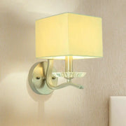 Modern brushed nickel bedside wall lamp with crystal features a cube bedside wall design with a beige fabric shade