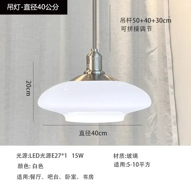A sleek white glass pendant light with brushed nickel fixture and dome shade for modern kitchen pendant lights