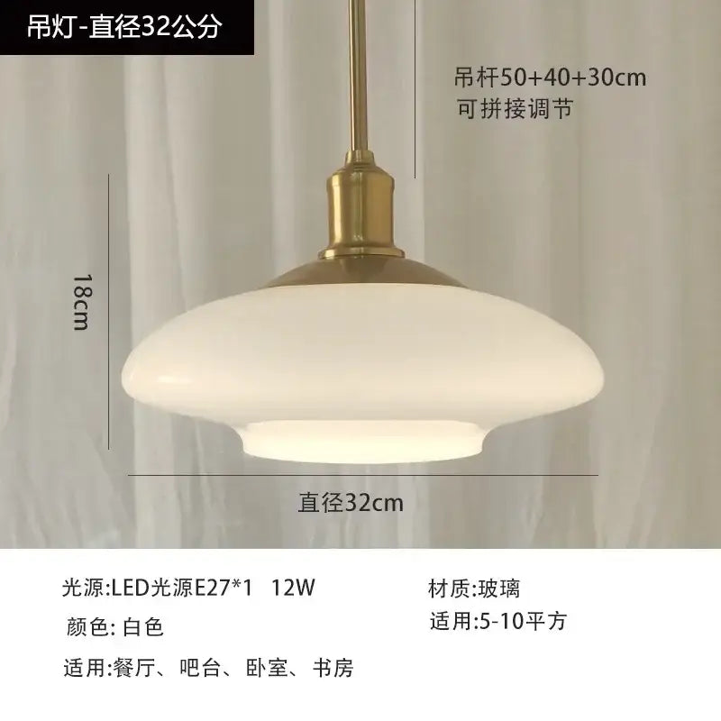 Modern brushed nickel glass pendant light with white glass shade and brass fixture perfect for kitchen pendant lights and home decor