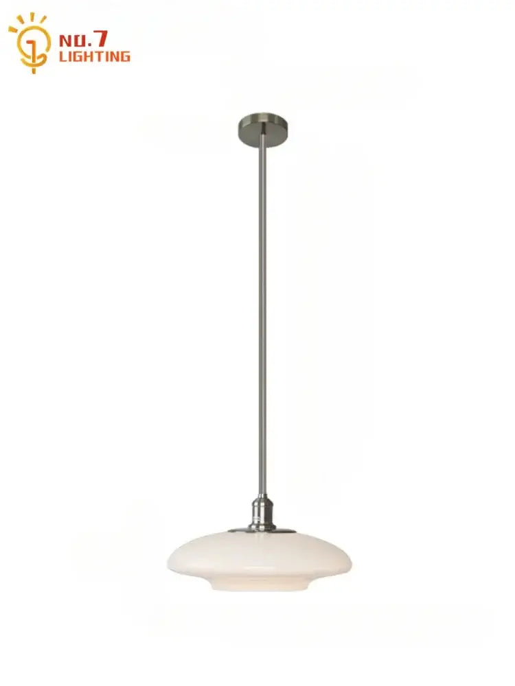 A sleek modern brushed nickel glass pendant light with opal shade for kitchen indoor lighting
