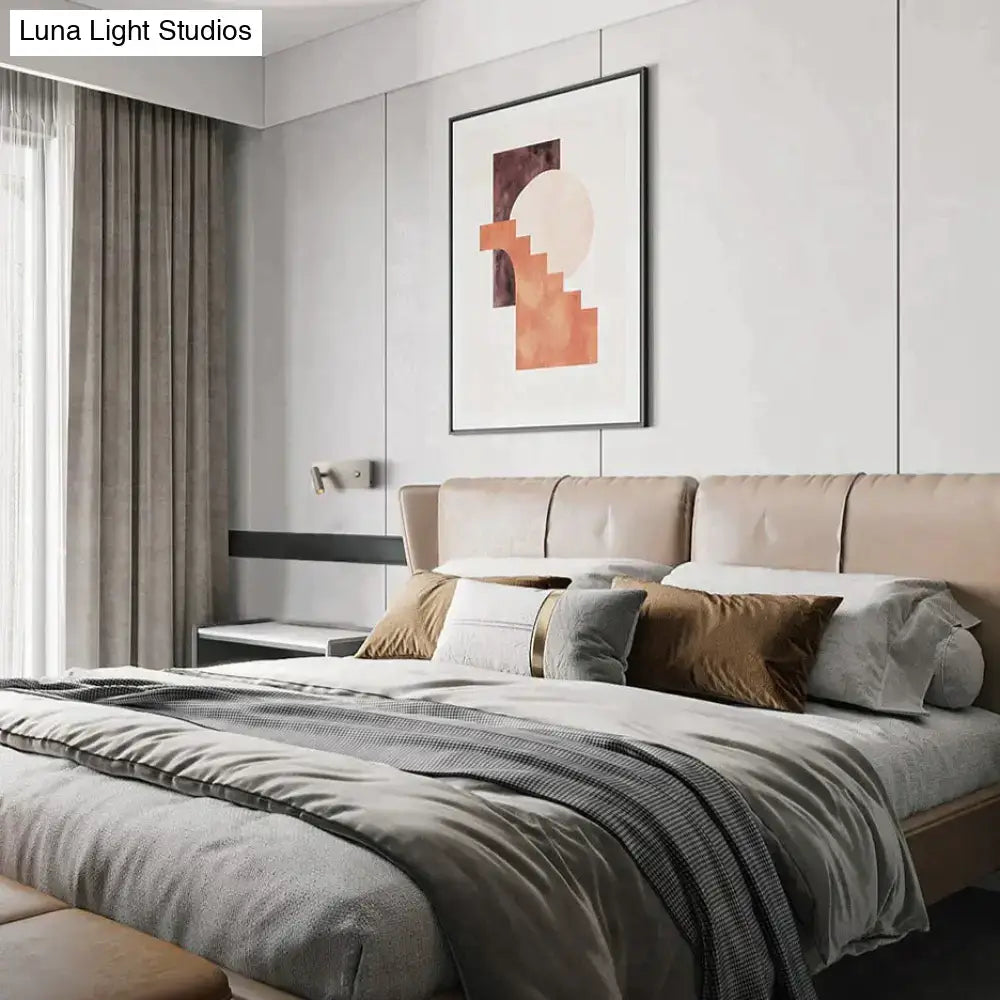 Beige upholstered bed with tufted headboard and neutral pillows featuring modern brushed nickel led dimmable reading wall light