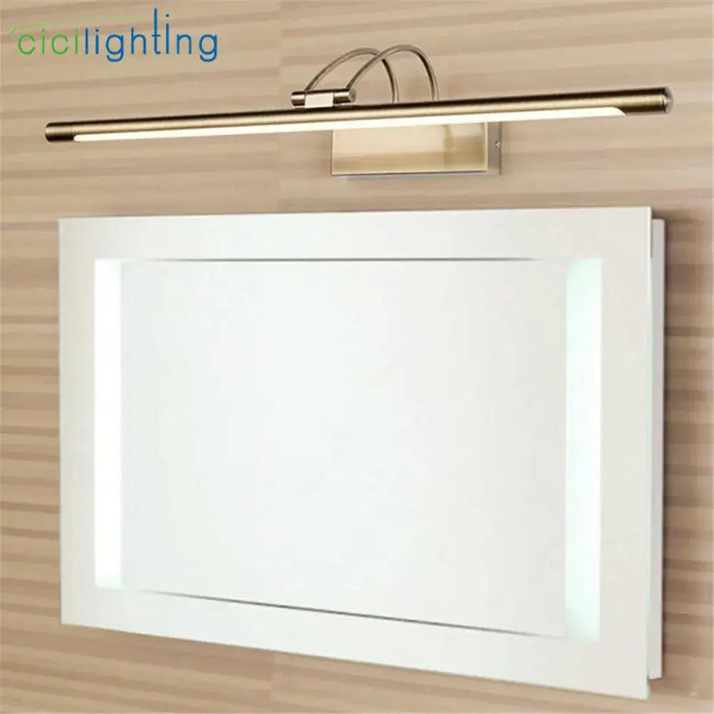 Modern brushed nickel led vanity light with gold finish and sleek design mounted above a white-framed mirror