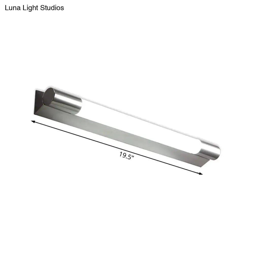 Modern brushed nickel wall light with stainless steel cylindrical design and frosted glass diffuser emitting warm white light