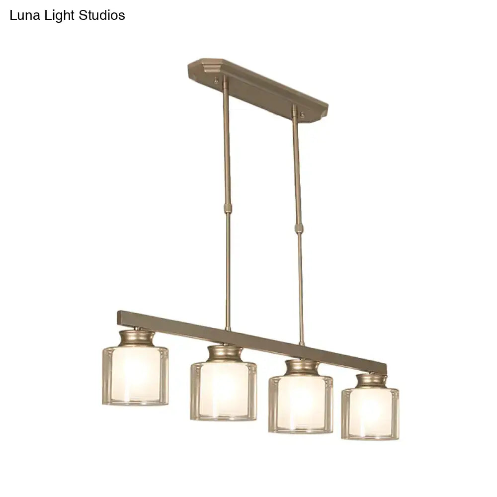 Modern brushed nickel pendant light with four clear glass shades and traditional gold accents for dining rooms