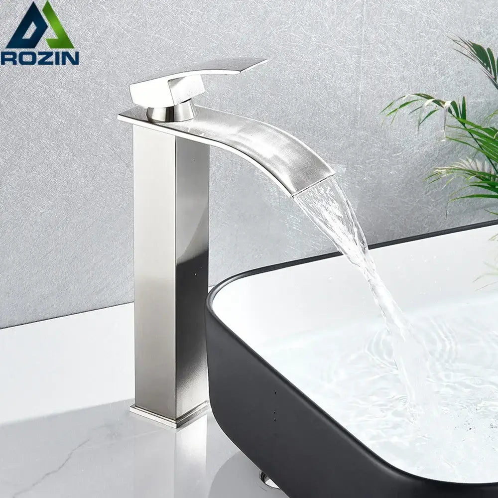 Modern brushed nickel single lever basin faucet with stainless steel waterfall design and polished finish for bathroom use