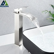 Modern brushed nickel single lever basin faucet with stainless steel waterfall design and polished finish for bathroom use
