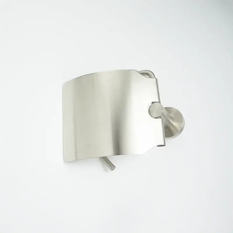 Stainless steel toilet paper holder with brushed nickel finish and sleek curved design in modern hardware set