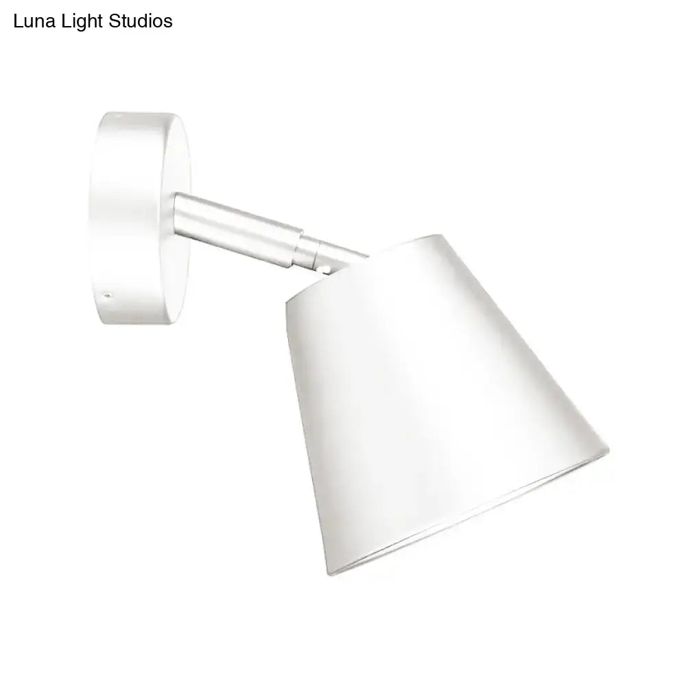 Modern brushed nickel tapered wall light with a white conical wall sconce and sleek metallic arm for bathroom use