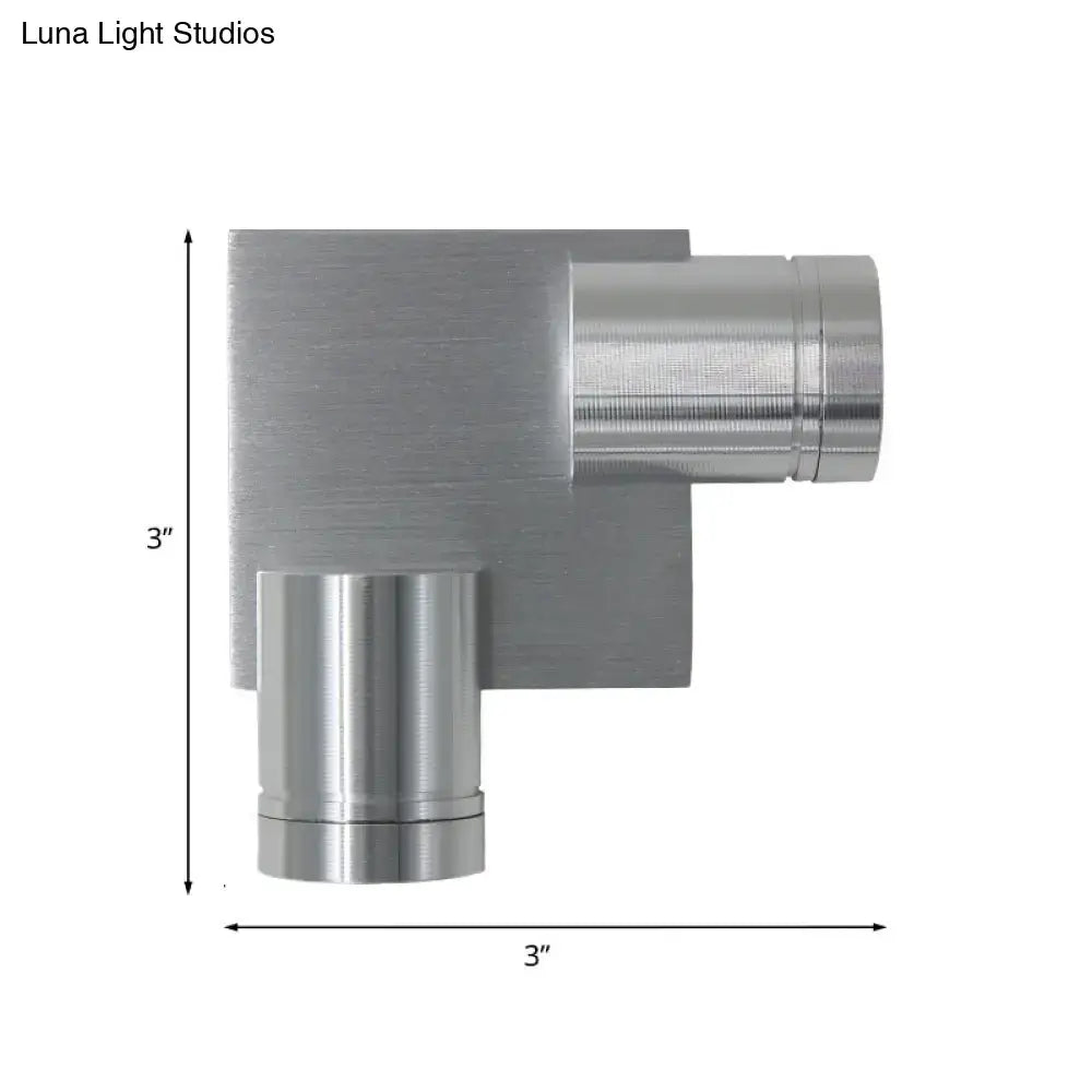 Modern brushed silver l-shaped wall light fixture with a 3-inch square base and cylindrical arms for bedroom use