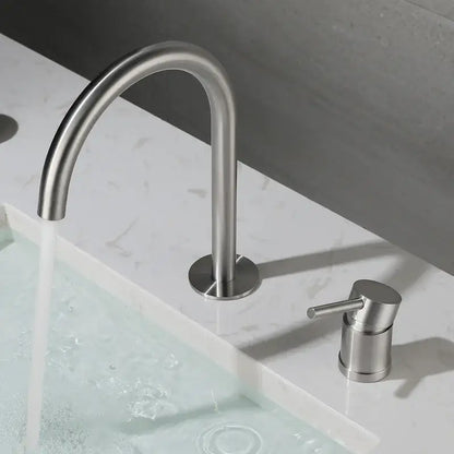Modern brushed stainless steel kitchen faucet with curved spout and separate cylindrical handle in brushed stainless finish