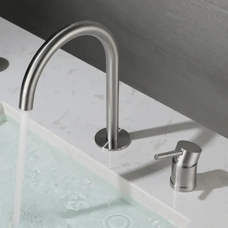 Modern brushed stainless steel kitchen faucet with curved spout and separate cylindrical handle in brushed stainless finish